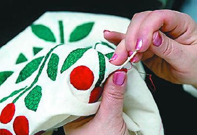 
Deborah Webb works on a quilt called the Second Hand Rose at the Waterford Retirement Community. 
 (The Spokesman-Review)