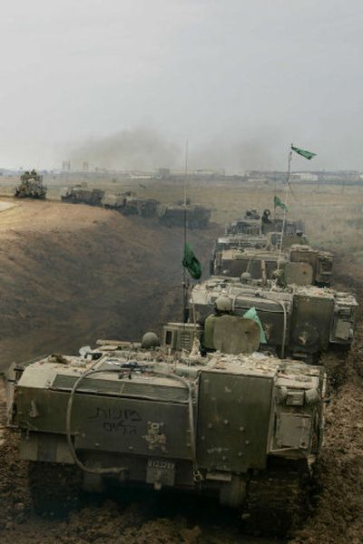 
A line of Israeli armored vehicles is seen just outside the Gaza Strip near Kibbutz Nahal Oz in southern Israel on Monday. 
 (Associated Press / The Spokesman-Review)