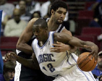 
Tim Duncan tries to knock the ball away from Orlando's Dwight Howard.
 (Associated Press / The Spokesman-Review)