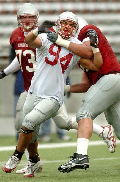 
Washington State defensive end Mkristo Bruce, center, works against Sean O'Connor, left, and Bobby Byrd. 
 (Joe Barrentine / The Spokesman-Review)