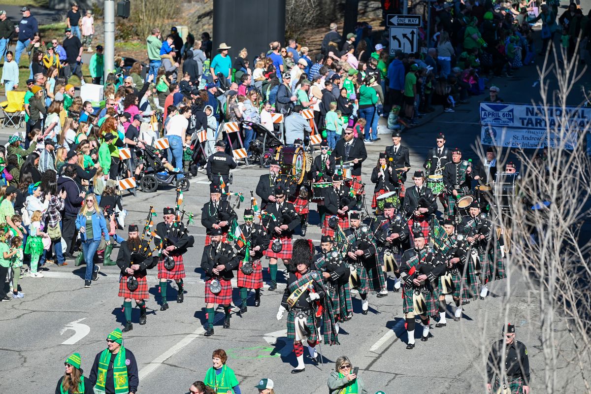 Following the color guard, the Spokane County Firefighters Pipes and Drums appears across Spokane Falls Boulevard on Washington Street near the start of the annual St. Patrick’s Day Parade on Saturday.  (Jesse Tinsley/THE SPOKESMAN-REVIEW)