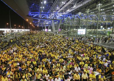 Anti-government protesters sit in front of the departure terminal at Suvarnabhumi airport today.  (Associated Press / The Spokesman-Review)