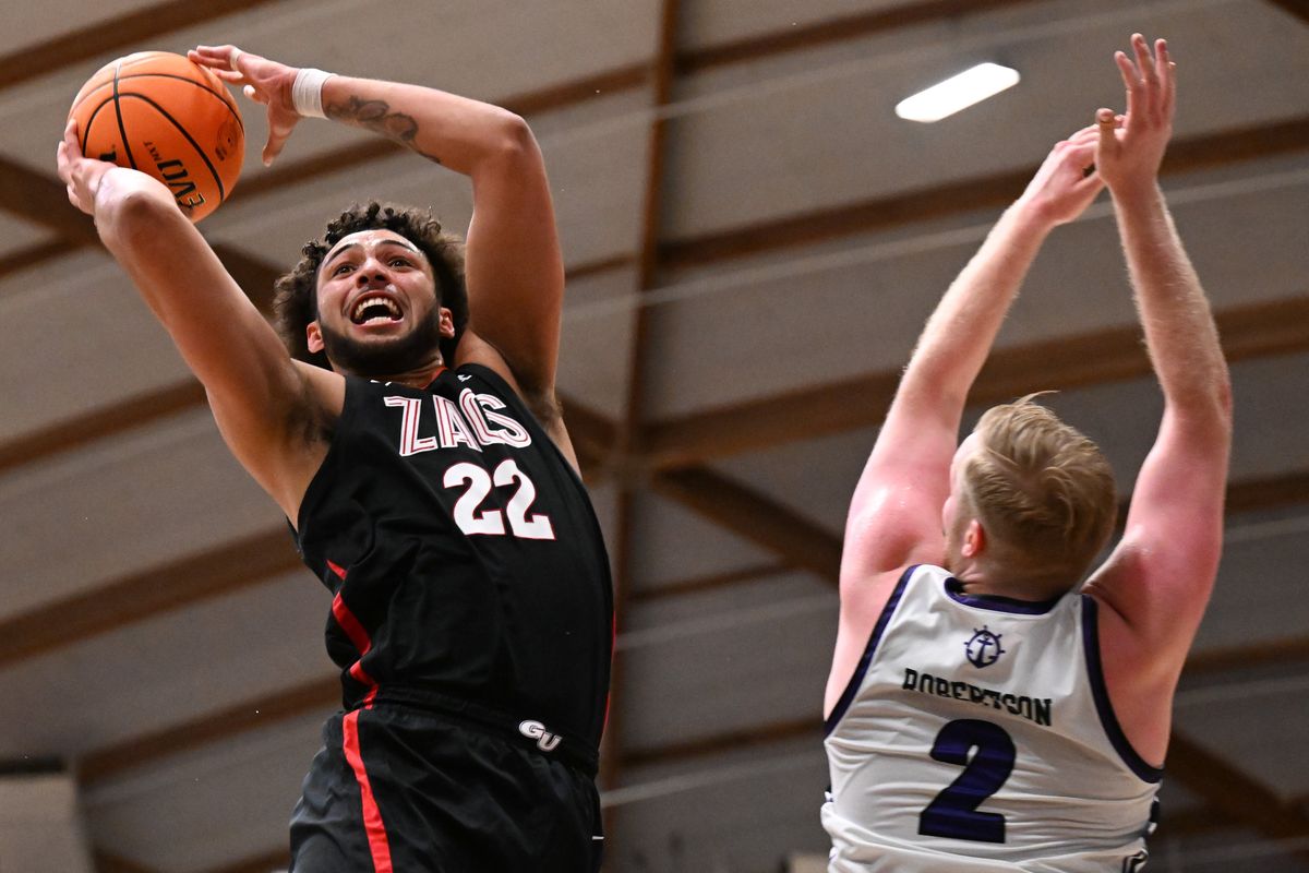 Gonzaga Bulldogs forward Anton Watson (22) shoots against Portland Pilots guard Tyler Robertson (2) during the second half of a college basketball game on Thursday, Feb. 22, 2024, at the Chiles Center in Portland, Ore. Gonzaga won the game 86-65.  (Tyler Tjomsland/The Spokesman-Review)