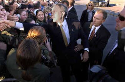 
President Bush reaches into a crowd of Air Force personnel at Fairchild shortly before taking off Thursday. Bush traveled on to Tacoma to speak to soldiers today at Fort Lewis.
 (Christopher Anderson/ / The Spokesman-Review)