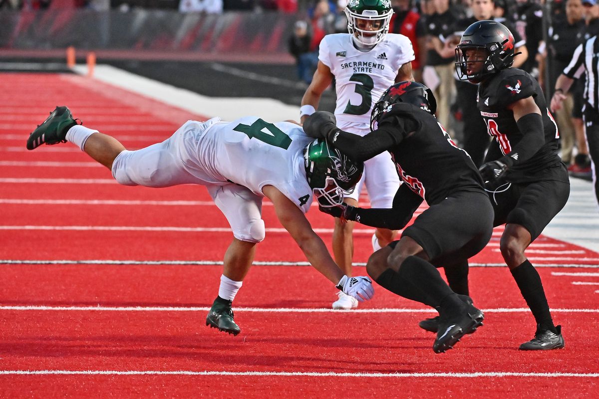 Eastern Washington Eagles defensive back Ely Doyle (25) brings down Sacramento State Hornets running back Cameron Skattebo (4) in the second half at Roos Stadium on Saturday Oct. 15 2022 in Cheney.  (James Snook/FOR THE SPOKESMAN-REVIEW)