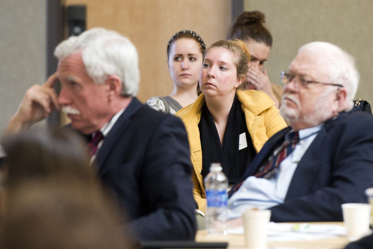 Jenny Shea, center, a volunteer at Volunteers of America, listens to a panel discussion about preventing suicide among young people Tuesday at Gonzaga University. Shea works with older teens in the foster care system. The daylong conference included discussions about effective programs, multistate coordination and counseling techniques. (Jesse Tinsley)