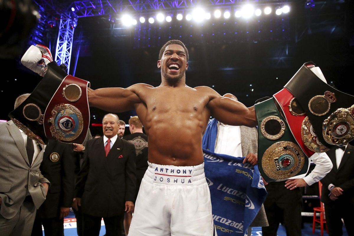 In this Sept. 22, 2018, photo, Anthony Joshua celebrates defeating Alexander Povetkin to retained his WBA, IBF, and WBO heavyweight boxing titles at Wembley Stadium in London. (Nick Potts / PA via AP)