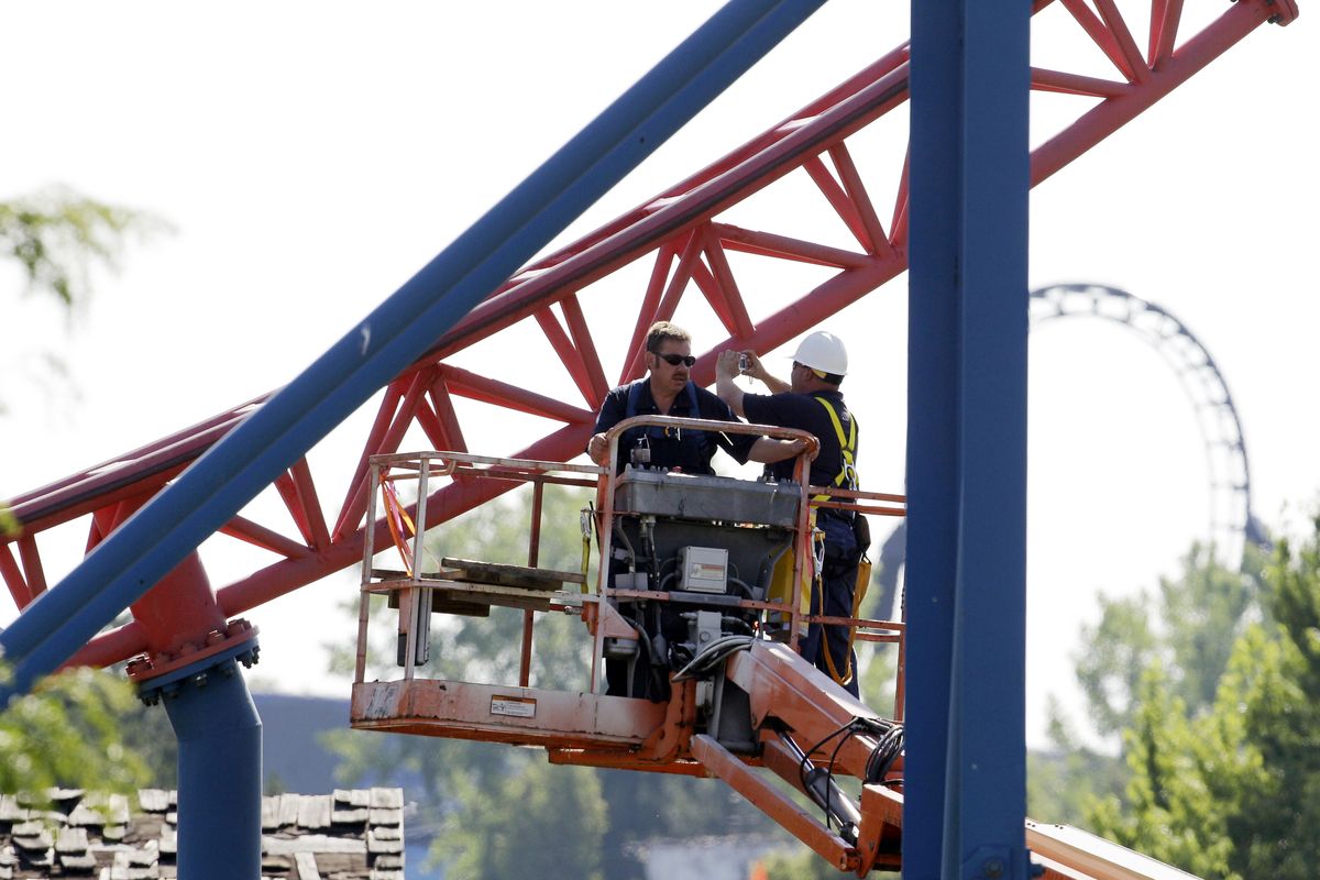 Workers inspect the 208-foot-tall Ride of Steel roller coaster at Darien Lake Theme Park Resort in Darien, N.Y., on Saturday. (Associated Press)