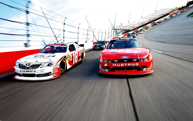 Pole winner Ricky Stenhouse Jr., right, and Denny Hamlin lead the field from the front row during pace laps for the NASCAR Nationwide Series' VFW Sport Clips Help A Hero 200 at Darlington Raceway on May 11, 2012. (Photo Credit: By John Harrelson, Getty Images for NASCAR) (John Harrelson / Getty Images North America)