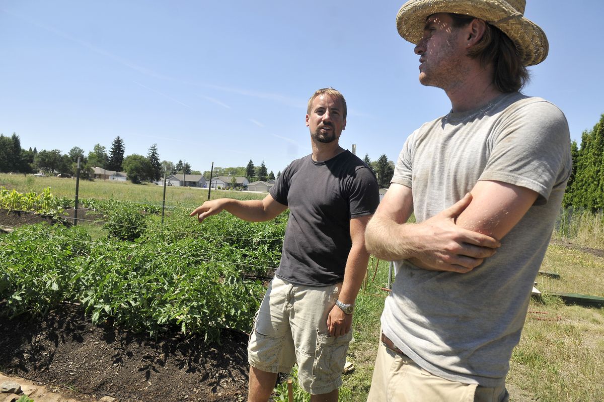 Sam Morris, left, and Omar Akkari talk Wednesday about their plans for the Fresh Start Community Garden, which Akkari started this year with the Spokane Valley Partners. (Jesse Tinsley)
