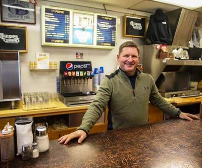 Steve Hudson, co-owner of Hudson Hamburgers with his brother, Todd, poses for a photo inside the downtown Coeur d'Alene institution Friday. (Loren Benoit/Coeur d'Alene Press)