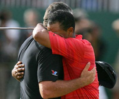 
Tiger Woods embraces his caddie Steve Williams after winning his second consecutive British Open.
 (Associated Press / The Spokesman-Review)