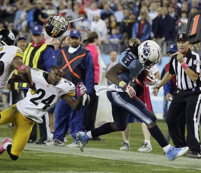 Steelers cornerback Ike Taylor loses his helmet as he chases Titans running back Chris Johnson. (Associated Press)
