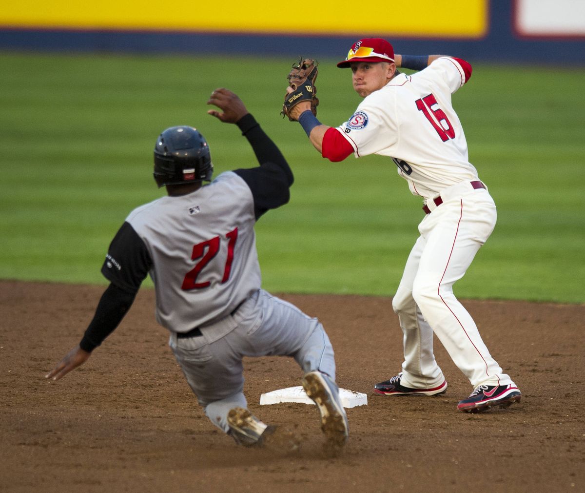 Spokane second baseman Ryan Rua forces Salem-Keizer's Dashenko Ricardo out at second base. The attempted double play was not successful. (Colin Mulvany)