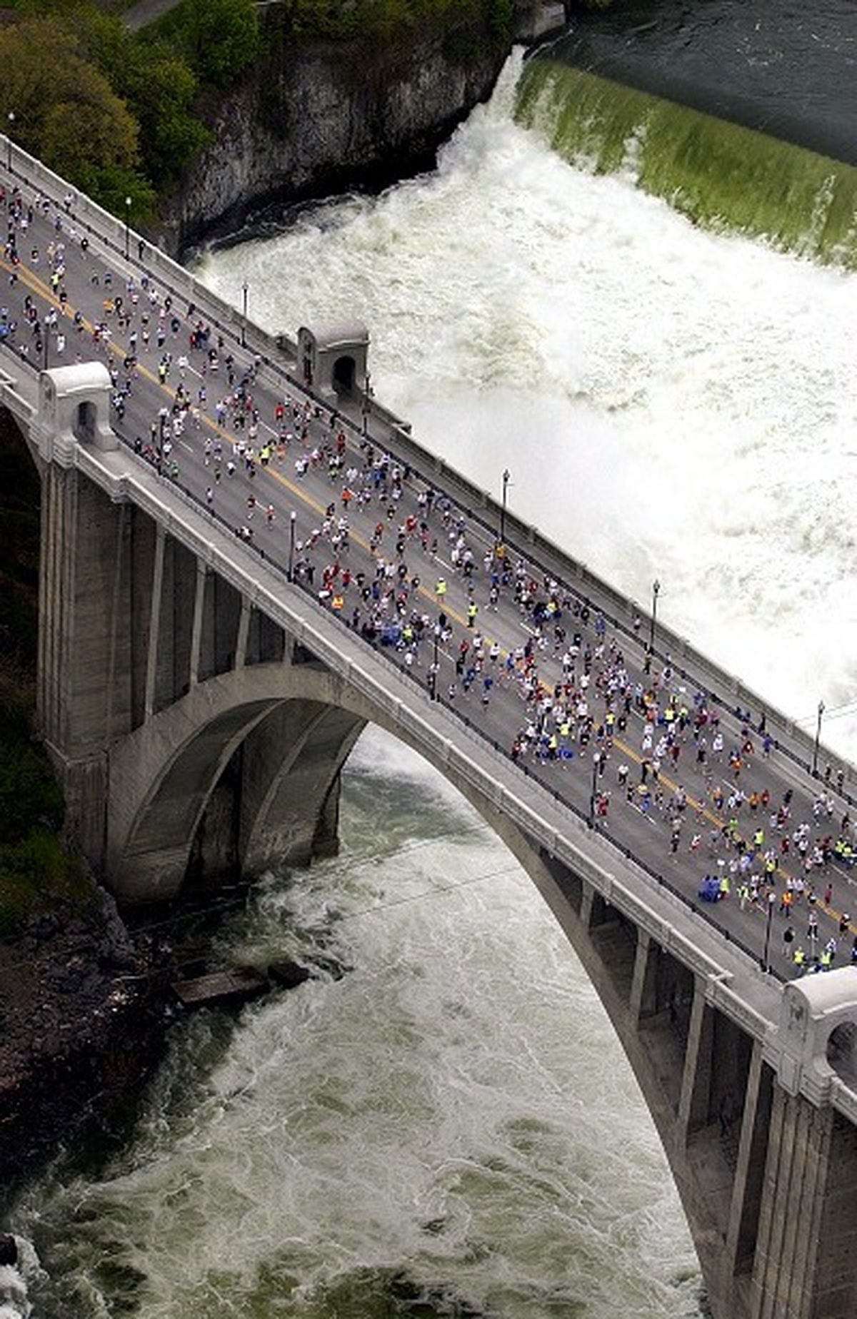 The lower Spokane River Falls served as a backdrop for Bloomsday finishers on the Monroe St. Bridge, May 7, 2006. J. BART RAYNIAK The Spokesman-Review (The Spokesman-Review)