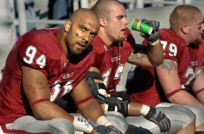 
Mkristo Bruce, left, and Adam Braidwood, center, tend to agree on giving Washington State University's uniforms a positive review.
 (Christopher Anderson/ / The Spokesman-Review)