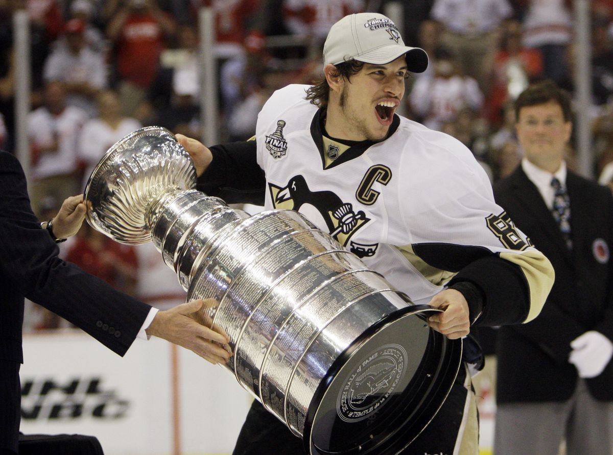 Sidney Crosby of the Penguins was happy to get his hands on the Stanley Cup for the first time.  (Associated Press / The Spokesman-Review)