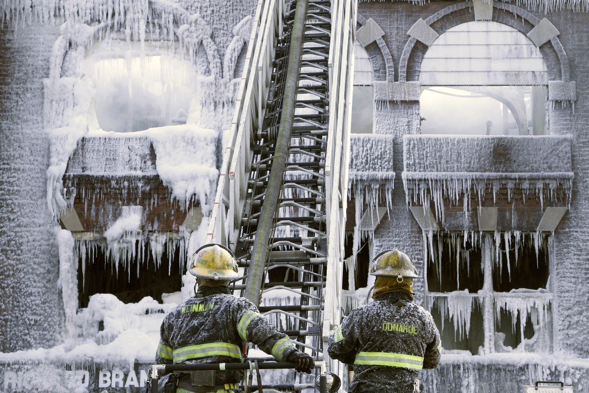 Philadelphia firefighters work the scene of an overnight blaze in west Philadelphia on Monday, as icicles form where the water from their hoses froze. (Associated Press)