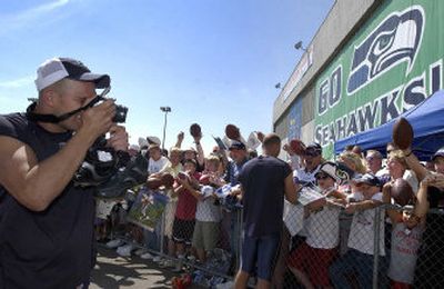 
 Seahawks quarterback Matt Hasselbeck has a role reversal as he photographs the fans after practice on Monday in Cheney. 
 (Dan Pelle / The Spokesman-Review)