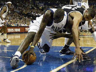 
Tim Duncan and Dallas' DeSagana Diop battle for a loose ball. 
 (Associated Press / The Spokesman-Review)
