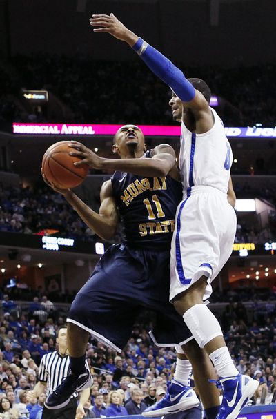 Murray State guard Donte Poole goes to the basket against Memphis guard Chris Crawford during first half Sunday. (Associated Press)