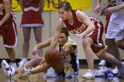 
Mead's Alysha Green, left, and Ferris senior guard Patty Duncan contend for a loose ball in the Panthers' 51-32 win. 
 (Holly Pickett / The Spokesman-Review)