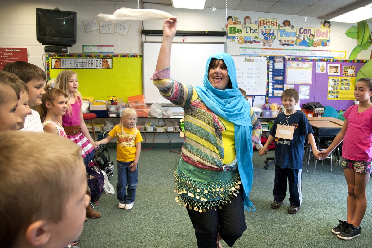 Opportunity Elementary School fourth-grade teacher Laurie Spence and students dance the Dabke, a traditional Lebanese dance, during International Day on Wednesday in Spokane Valley. The five-step dance is often performed at weddings. (Dan Pelle)