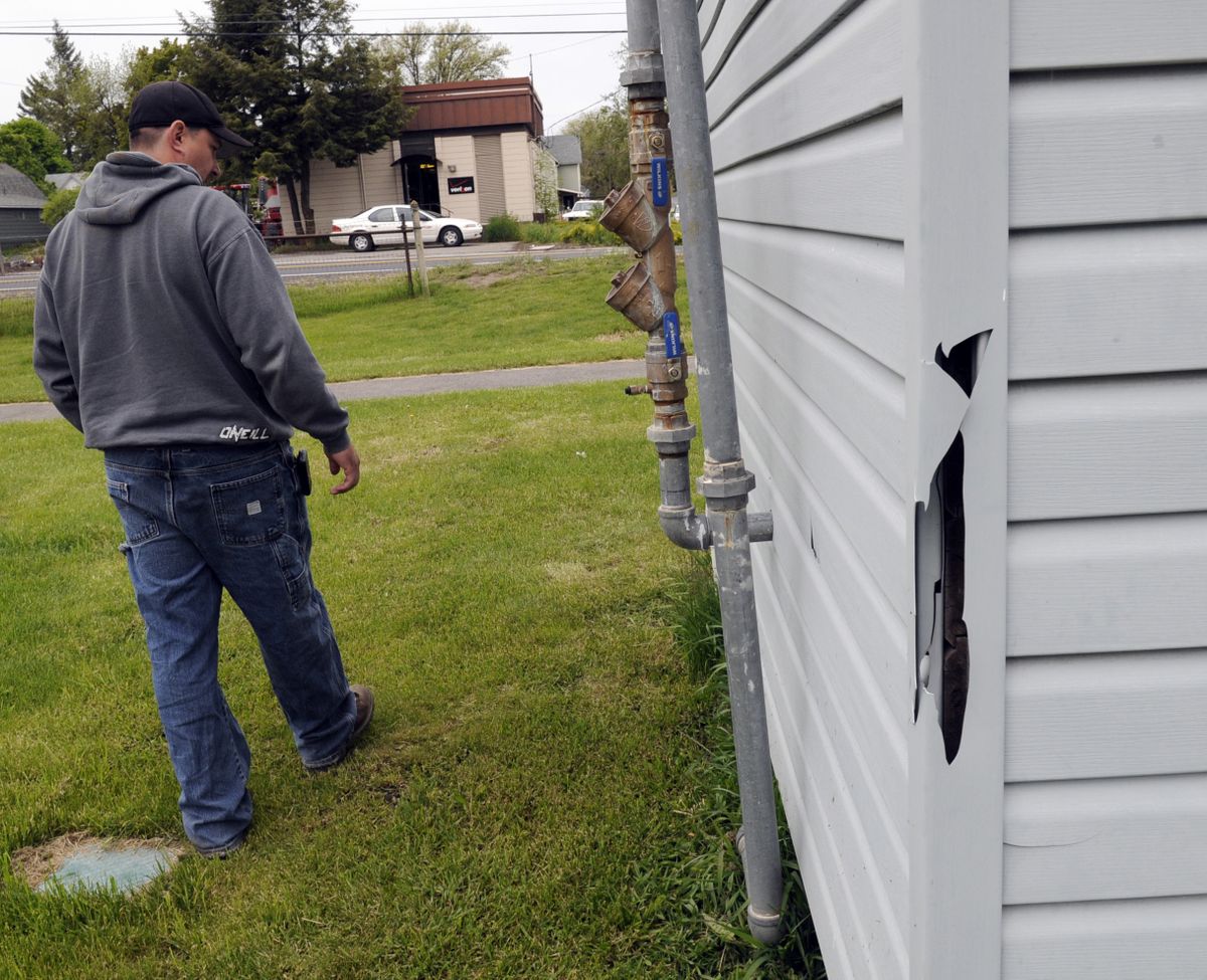 bartr@spokesman.com Fairfield public works Director Travis Glidewell inspects torn siding on the well house in Theil Park. The city recently installed $5,600 worth of surveilance cameras to help curb vandalism in the popular park. (J. BART RAYNIAK)