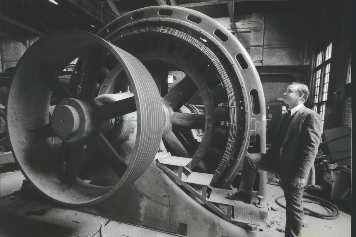 John Bowditch, of the Henry Ford Museum in Dearborn, Michigan, admires a Washington Water Power hydroelectric turbine in July 1990. The turbine was installed in 1903 in the Monroe Street Dam. Bowditch was in Spokane to inspect it before it was removed and sent to the museum where it remains on display.  (Colin Mulvany/The Spokesman-Review)