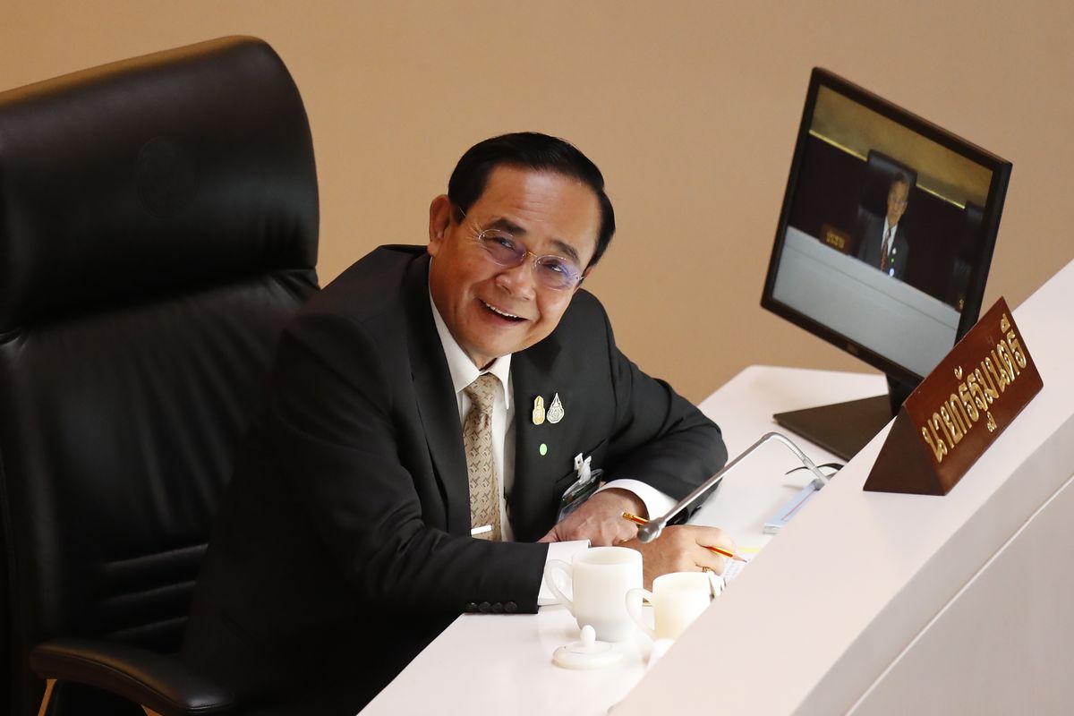 Thailand Prime Minister Prayuth Chan-ocha smiles in parliament after a no-confidence vote against him was defeated in Bangkok, Thailand Saturday, Feb. 20, 2021. Prayuth survived a no-confidence vote Saturday in parliament amid allegations that his government mismanaged the economy, bungled the provision of COVID-19 vaccines, abused human rights and fostered corruption.  (Sakchai Lalit)