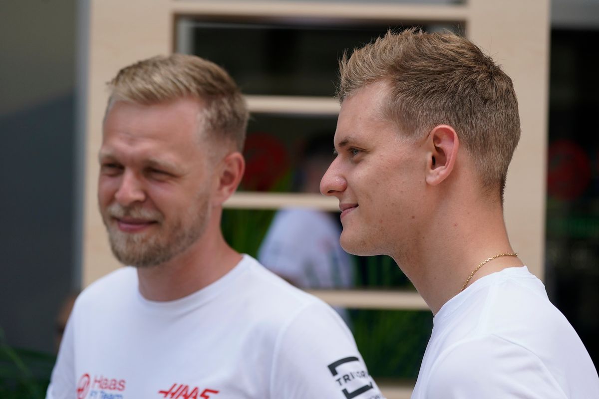Haas driver Kevin Magnussen, left, of Denmark, stands with Haas driver Mick Schumacher, of Germany, during an interview ahead of the Formula One Miami Grand Prix auto race at Miami International Autodrome, Thursday, May 5, 2022, in Miami Gardens, Fla.  (Darron Cummings)