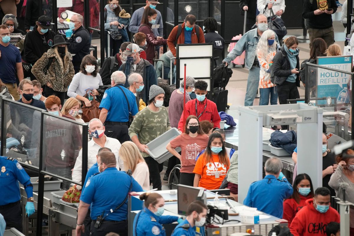 Travelers queue up at the south security checkpoint as traffic increases with the approach of the Thanksgiving Day holiday Tuesday, Nov. 23, 2021, at Denver International Airport in Denver.  (David Zalubowski)