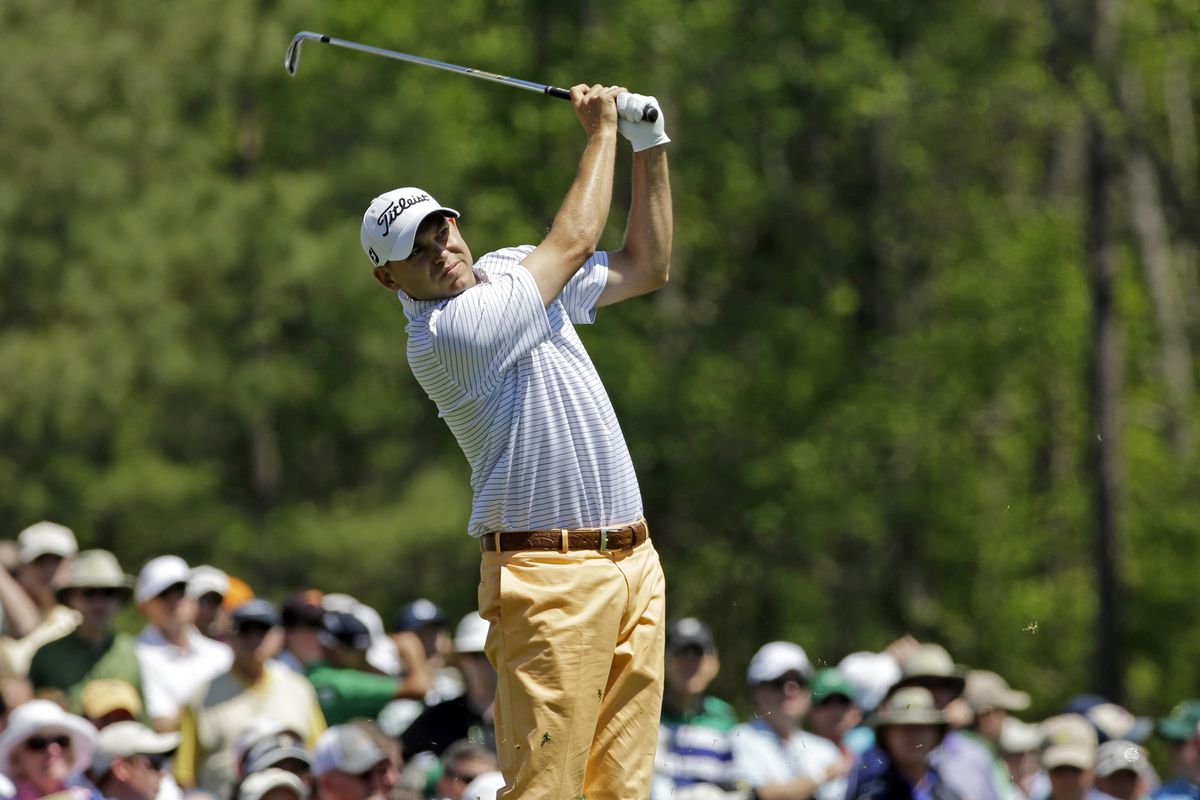 First-round leader Bill Haas tees off on the 12th hole Thursday. (Associated Press)