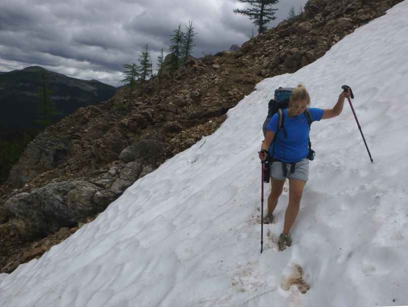 Hikers can encounter dangerous cross-slope stretches of snow at high mountain passes in July, such as this patch where a hiker narrowly escaped injury after slipping and sliding to the rocks below near Ball Pass in Banff National Park. (Rich Landers)