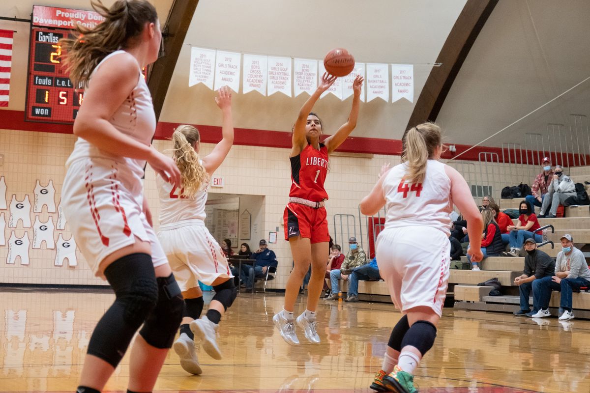 Liberty guard Teagan Colvin hits a 3-pointer over the Davenport defense on Tuesday in Davenport.  (Madison McCord/For The Spokesman-Review)