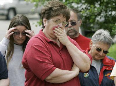 
Maytag workers listen to Iowa Gov. Tom Vilsack speak at a news conference, Wednesday after Maytag's parent company, Whirlpool Corp., announced Wednesday that it will close its Newton headquarters and manufacturing plant in October of 2007.
 (Associated Press / The Spokesman-Review)