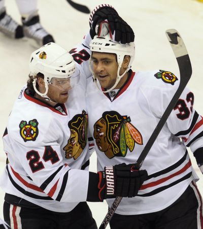 Martin Havlat, left, and Dustin Byfuglien are enjoying the Chicago Blackhawks’ rebirth this season. (Associated Press / The Spokesman-Review)