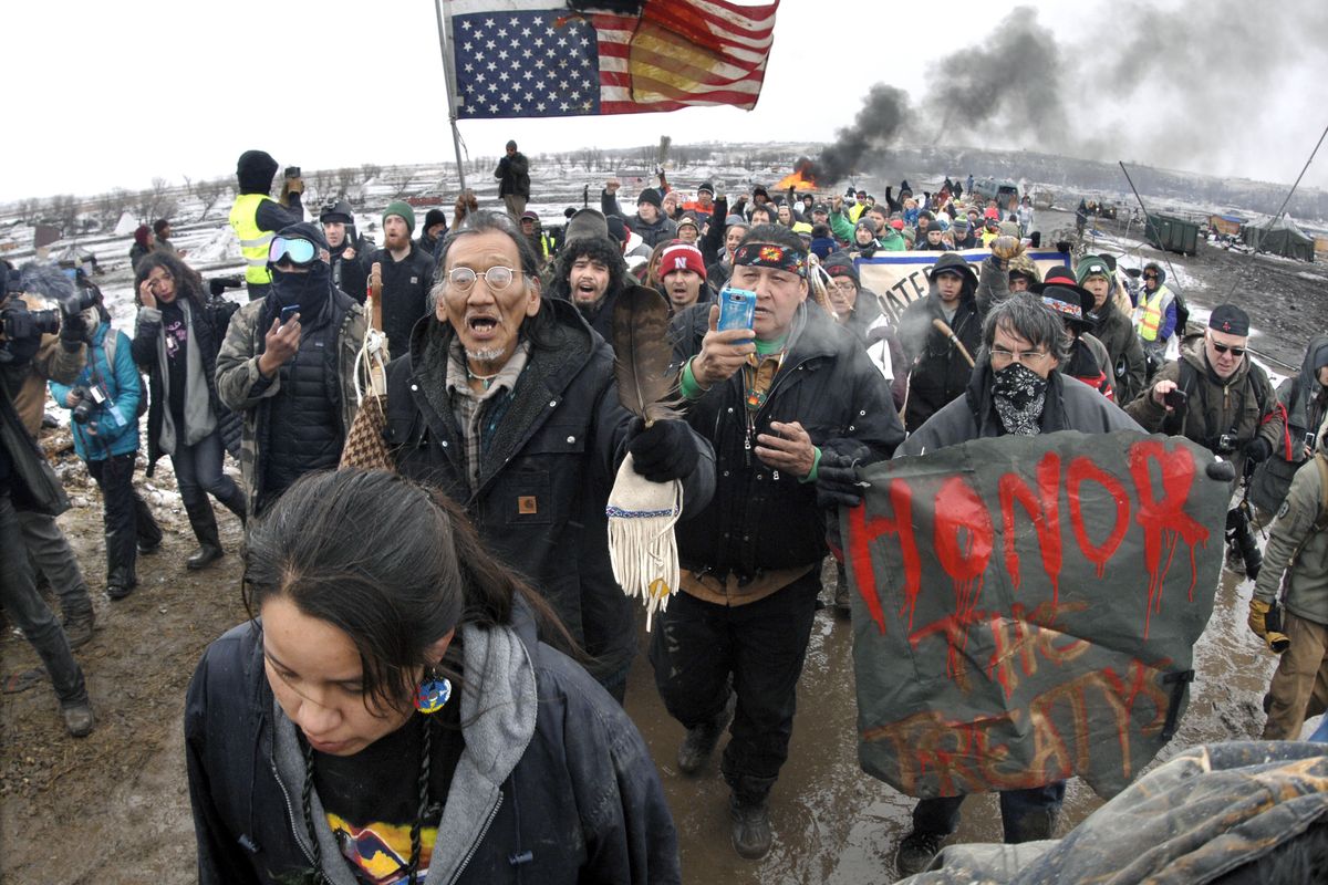 FILE - In this Feb. 22, 2017, file photo, a large crowd representing a majority of the remaining Dakota Access Pipeline protesters march out of the Oceti Sakowin camp near Cannon Ball, N.D. After President Joe Biden revoked Keystone XL