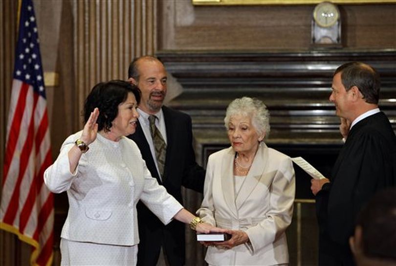 Sonia Sotomayor, left, President Obama's choice to replace retiring Justice David Souter, takes the oath from Chief Justice John Roberts to become the Supreme Court's first Hispanic justice and only the third woman in the court's 220-year history, in Washington, Saturday, Aug. 8, 2009. She is joined by her brother, Juan Luis Sotomayor, and her mother Celina Sotomayor. Sotomayor, 55, has been a federal judge for 17 years. The Senate confirmed Sotomayor's nomination Thursday by a 68-31 vote. (AP Photo/J. Scott Applewhite) (J. Applewhite / Associated Press)