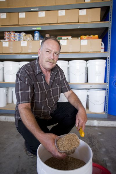 Jim Wiseman displays grain stored in his garage in La Jolla, Calif. The 54-year-old businessman has a backup generator, a water filter, a grain mill and a 4-foot-tall pile of emergency food.  (Associated Press / The Spokesman-Review)