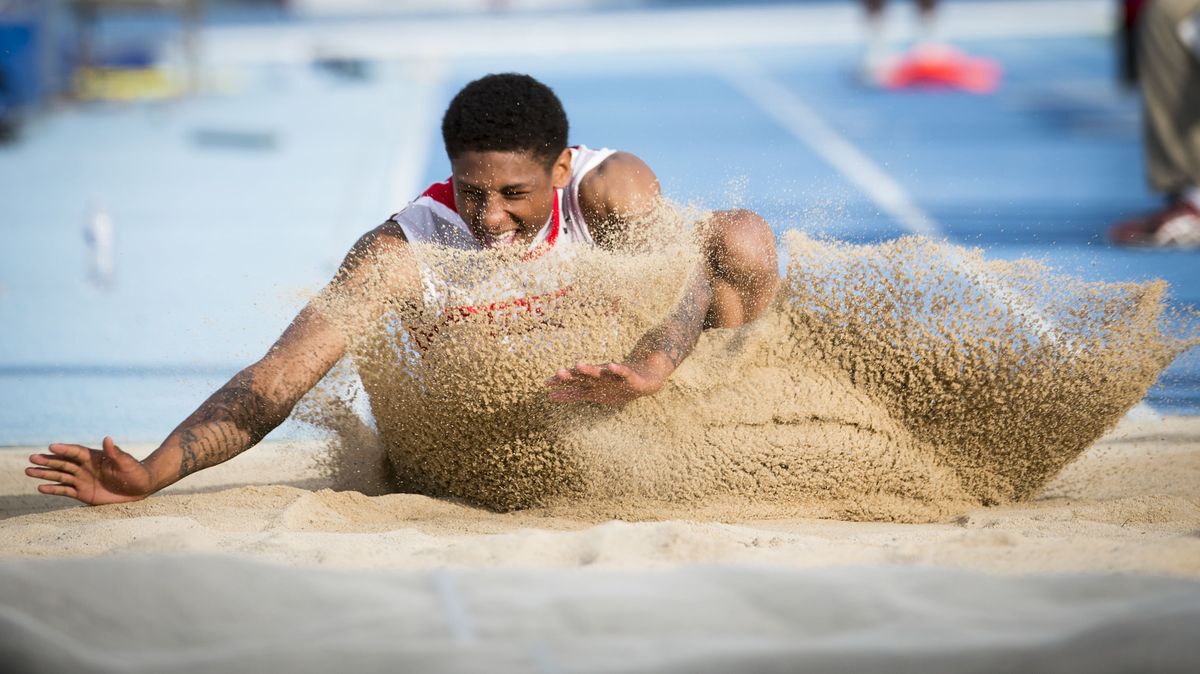 Jalen Hicks of Ferris lands in the sand in the 4A triple jump competition. Hicks was second to Central Valley’s Parker Bowden. (Colin Mulvany)