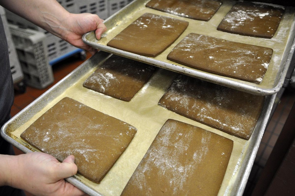 Corporate executive chef Ricky Webster shows off baking sheets of gingerbread bricks he