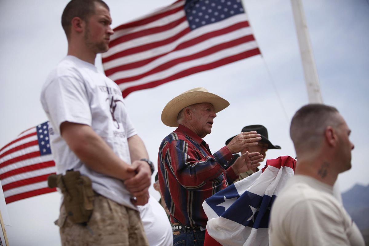 In this April 18, 2014, file photo, rancher Cliven Bundy, flanked by armed supporters, speaks at a protest camp near Bunkerville, Nev. Federal prosecutors will try again to convince a jury that four men conspired with Nevada rancher Bundy and his family when they took up arms during a 2014 standoff that stopped federal agents from confiscating cows belonging to the states’ rights advocate. Jury selection begins Monday, July 10, 2017. (John Locher / John Locher/Las Vegas Review-Journal)