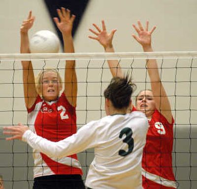 
Bonneville's Kara Keck, center, pounds a ball past Sandpoint's Brooke DeMers, left, and Christina Johnson in title match.
 (Jesse Tinsley / The Spokesman-Review)