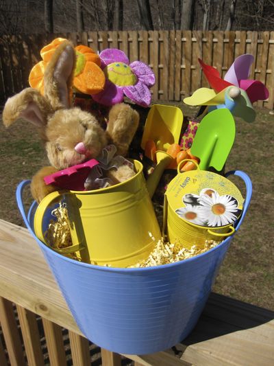 One Easter basket option includes a small plastic bucket holding a watering can, daisy grow kit, gardening gloves, pinwheel, various gardening tools, small gardening tote and plush toys. (Associated Press)