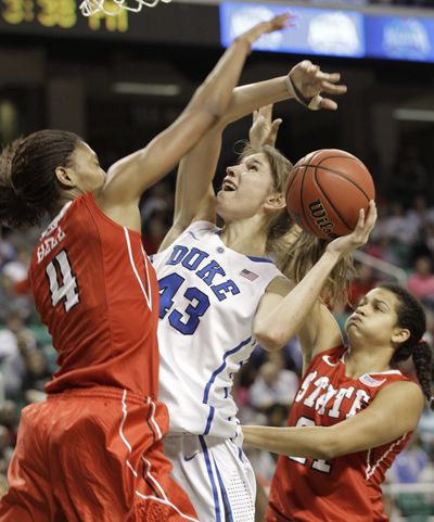 North Carolina State’s Tia Bell, left, and Erica Donovan clamp down on Duke's Allison Vernerey during first-half action Friday. (Associated Press)