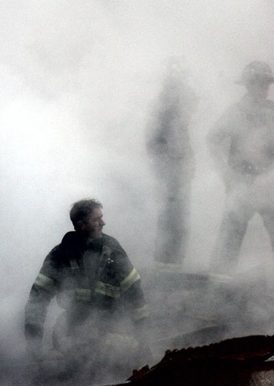 A firefighter emerges from the smoke and debris of the World Trade Center in New York City on Sept. 14, 2001.  (File Associated Press)