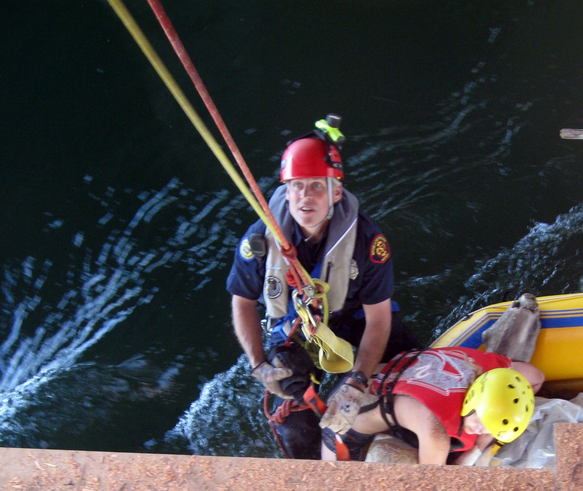 Spokane Valley firefighter Dave Griffiths rescues a woman whose raft got caught on a temporary pier  May 31, at the Barker Road Bridge, which is being rebuilt.  Photo courtesy of Spokane Valley Fire Department (Photo courtesy of Spokane Valley Fire Department / The Spokesman-Review)