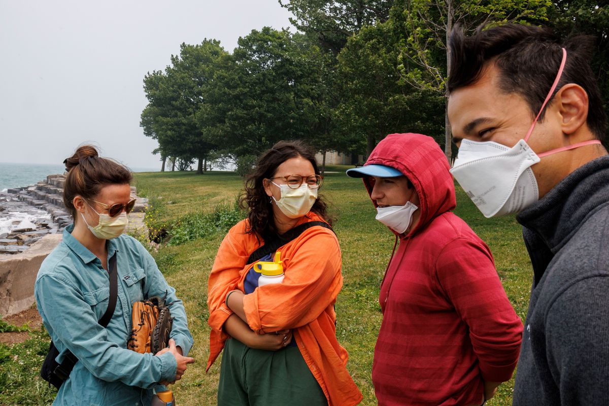 Aly Bothman, from left, Miranda Mireles, Max Loy and Liam Mireles wear masks at Promontory Point while smoke from Canadian wildfires passes hangs over the region on June 27, 2023 in Chicago.    (Armando L. Sanchez/Chicago Tribune/TNS)