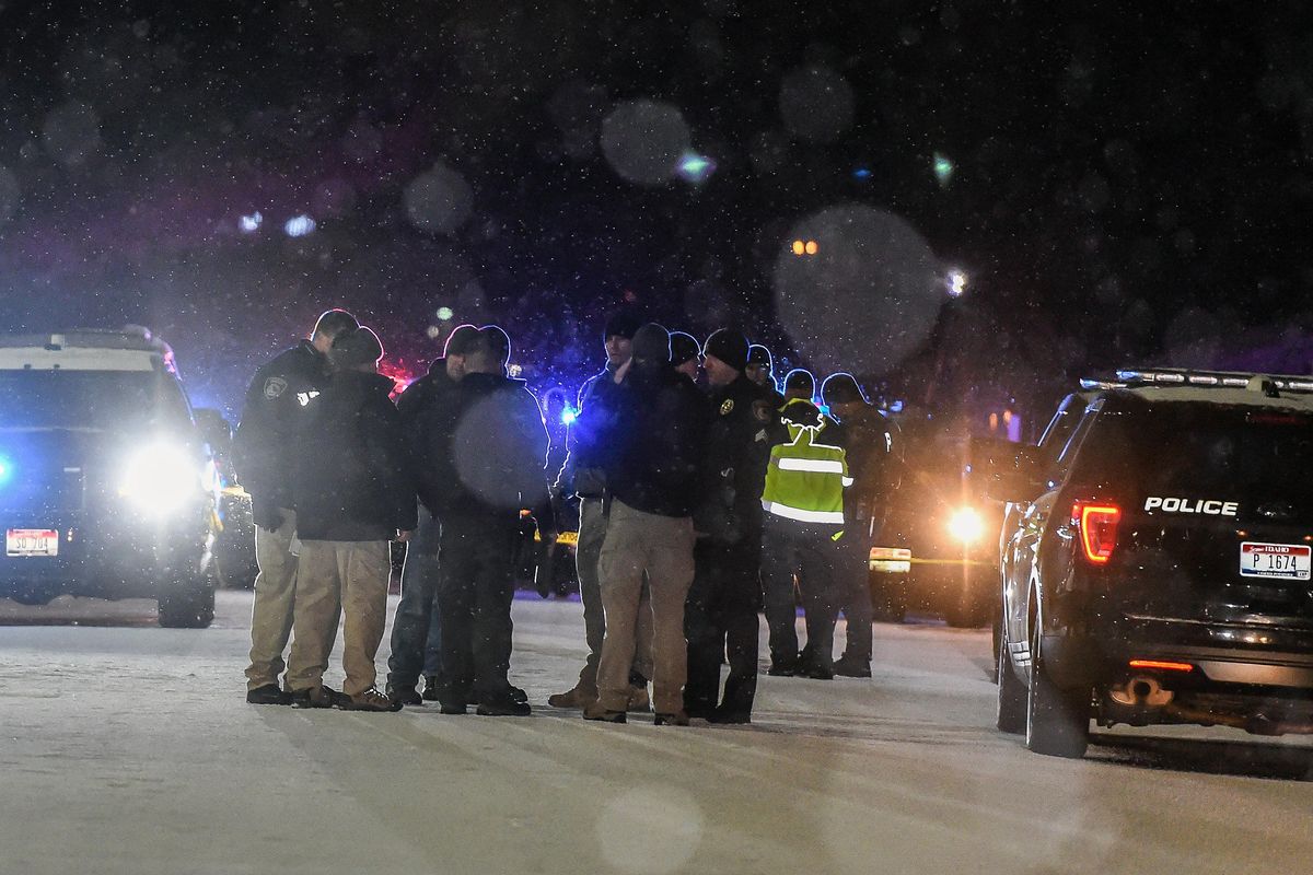 Law enforcement gather near the scene on Hattie Ave in Coeur dAlene were a police office was shot Tuesday night. (Colin Mulvany / The Spokesman-Review)